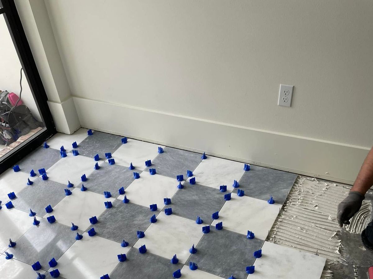 Marble checkerboard tile being set on the diagonal
