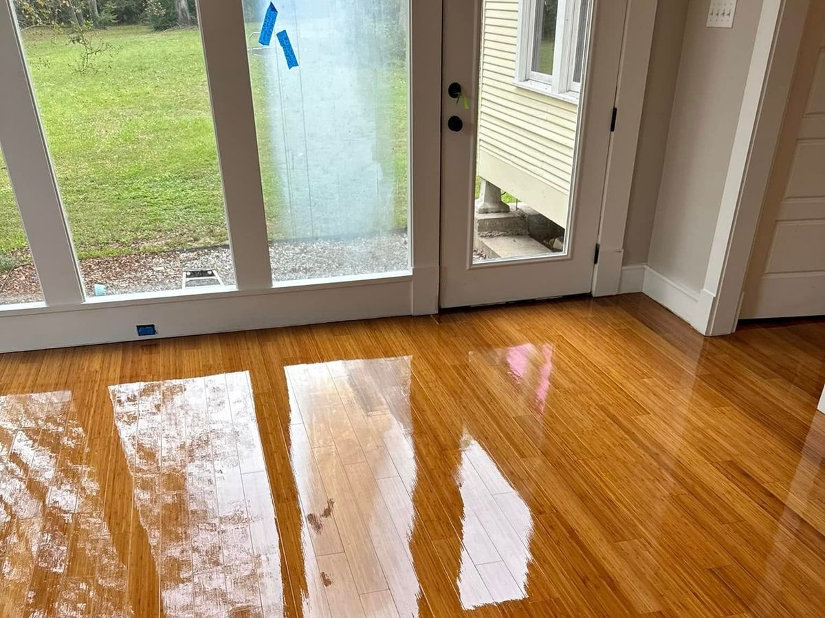 Close view of a glossy amber floor reflecting a wall of windows