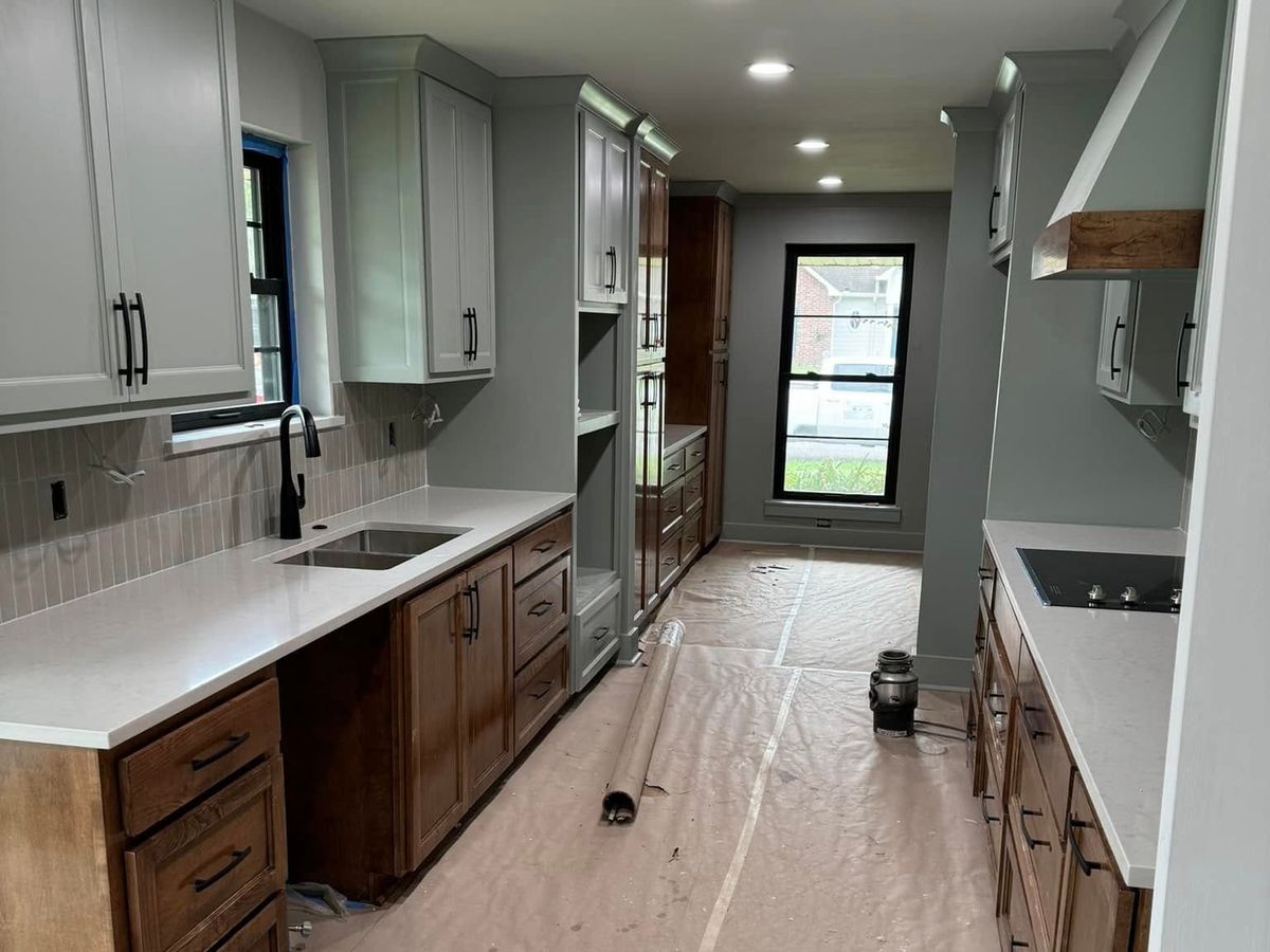 New galley kitchen with a tile backsplash and black-framed windows