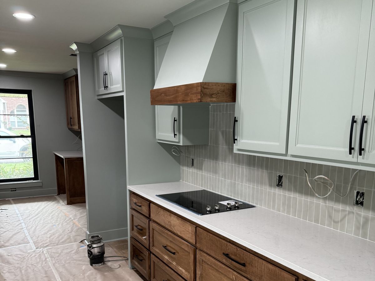 Sage uppers and stained lower cabinets with white quartz
