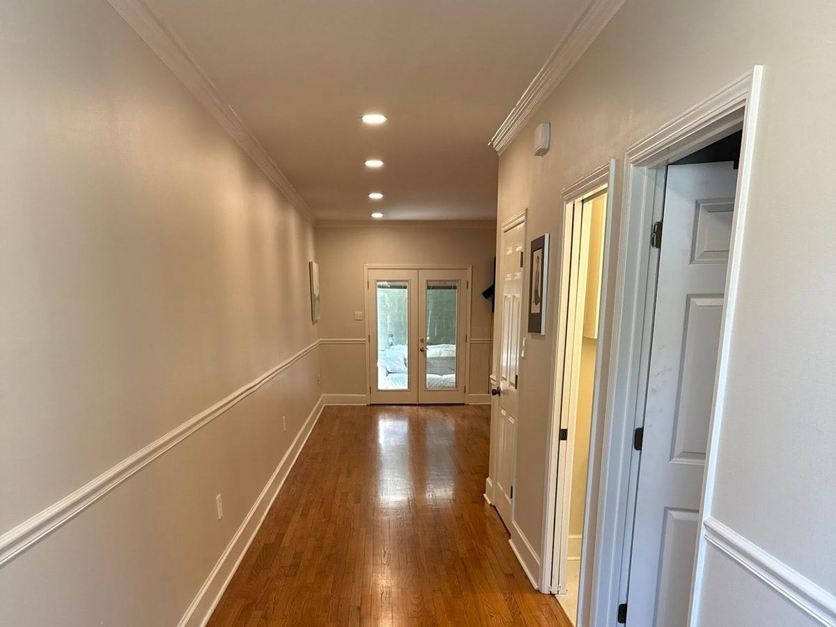 A refinished oak hallway leading to French doors