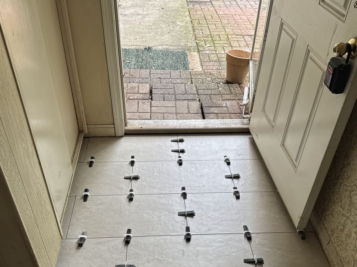 Back door threshold with new cream porcelain floor tile