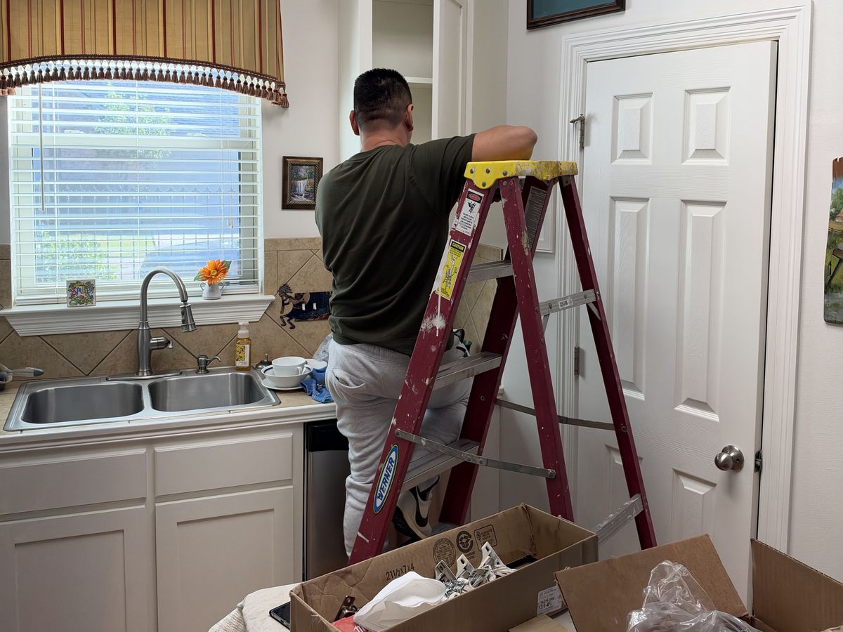 Cabinet install in a kitchen with a double sink and white door