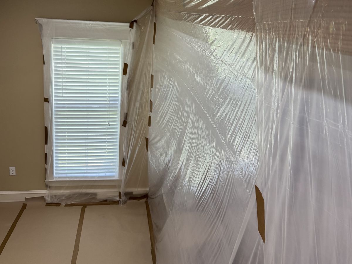Room prepared for painting with plastic over the window