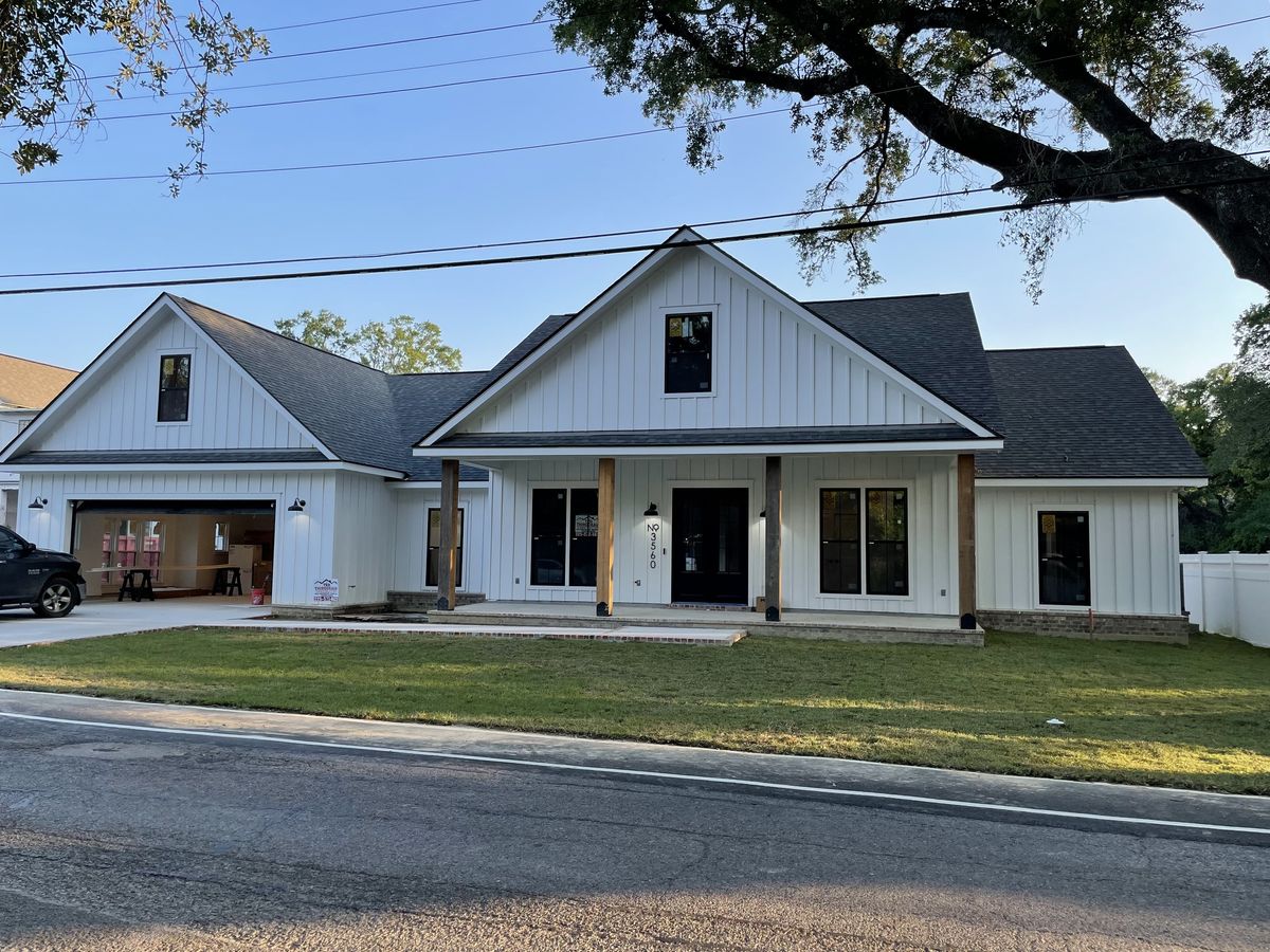 Street view of a finished white modern farmhouse
