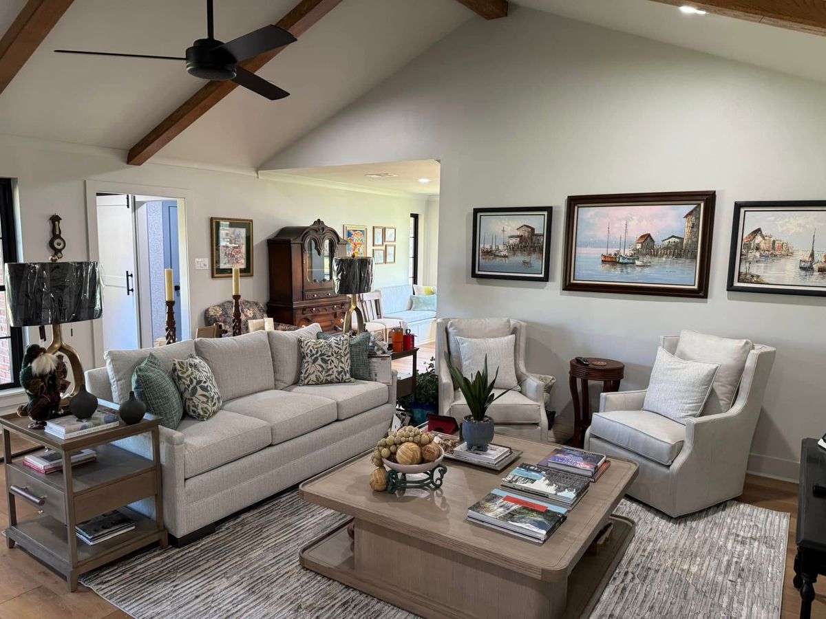 Living room under a vaulted ceiling with stained wood beams