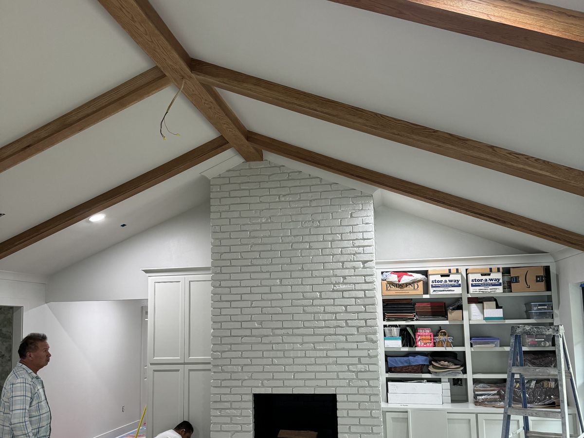 Living room renovation with a tall white painted brick fireplace