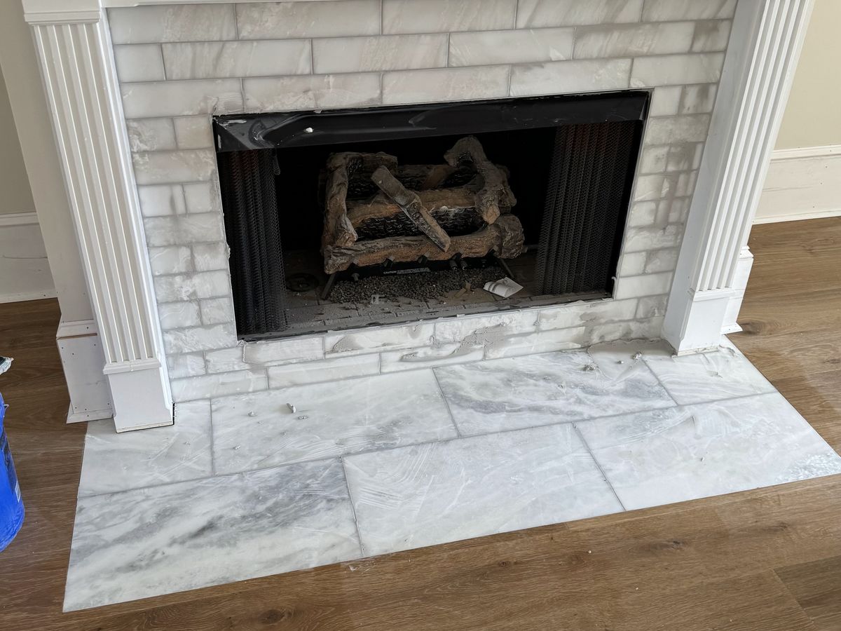 White marble slab hearth under a paneled mantel
