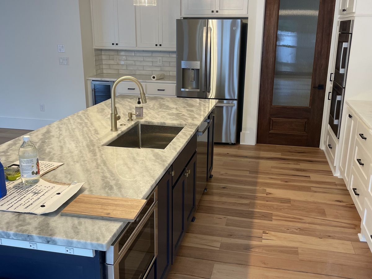 Navy island with an undermount sink and gold faucet