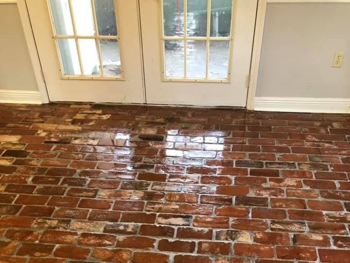 Finished reclaimed red brick floor with a glossy sealed surface