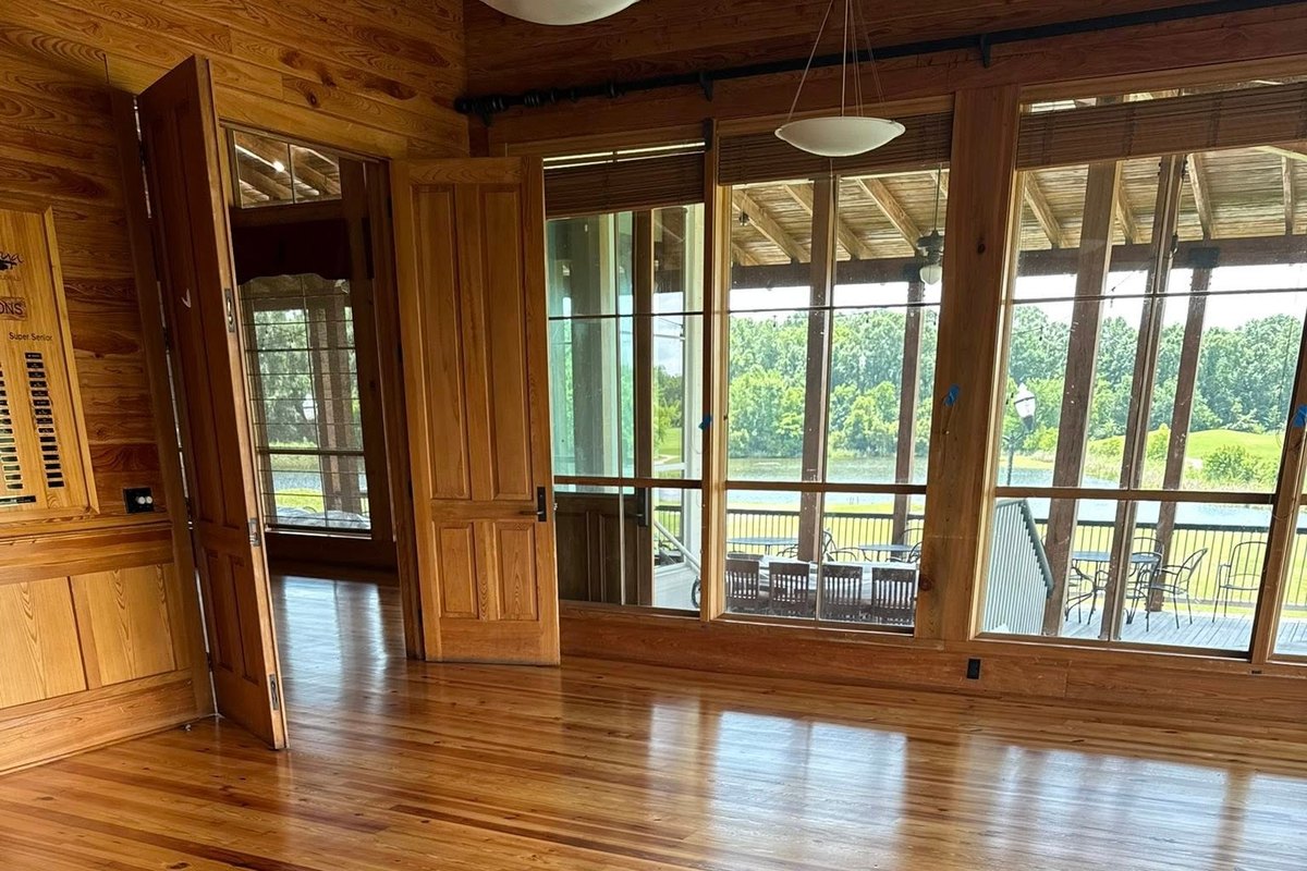 Large room with a refinished heart pine floor glowing amber