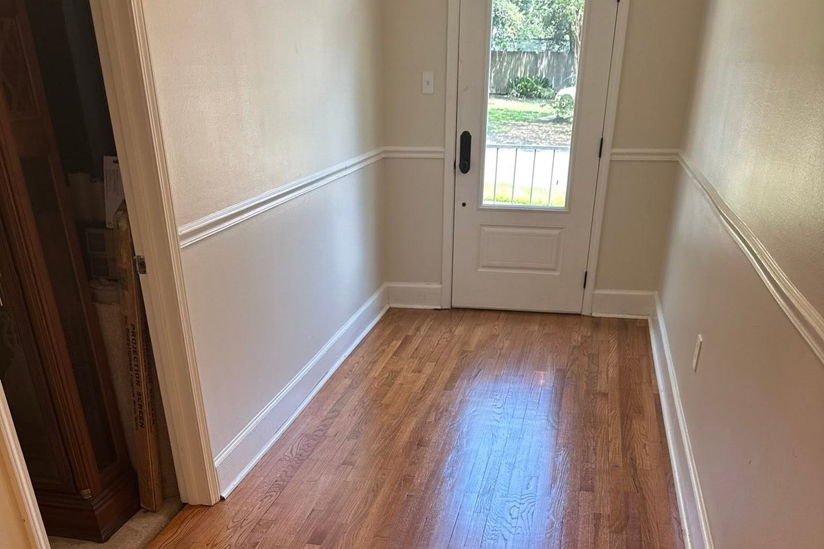 Entry hall floor of honey-toned oak, freshly refinished