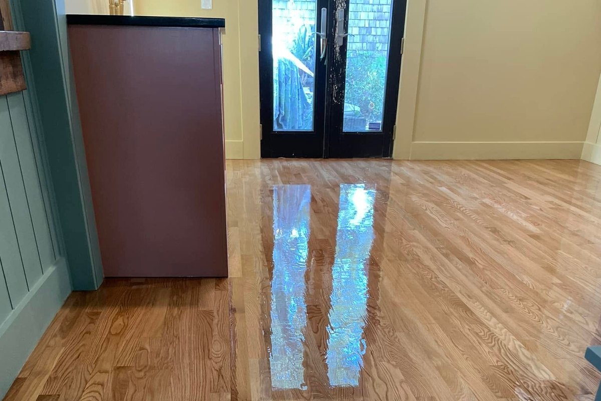 Long room with a refinished natural red oak floor in mirror gloss