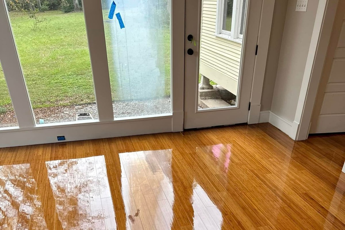 Refinished amber floor in a mirror gloss reflecting glass doors