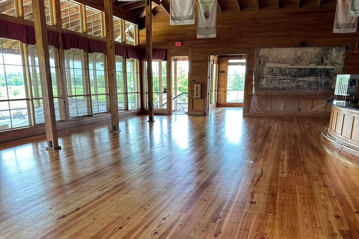Long hall with refinished heart pine and rough wood posts