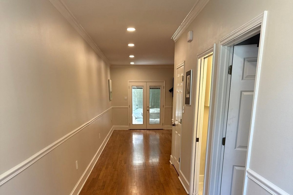 Long hallway with a refinished honey-toned red oak floor