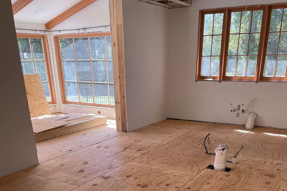 Room down to a new plywood subfloor with a drain pipe stub
