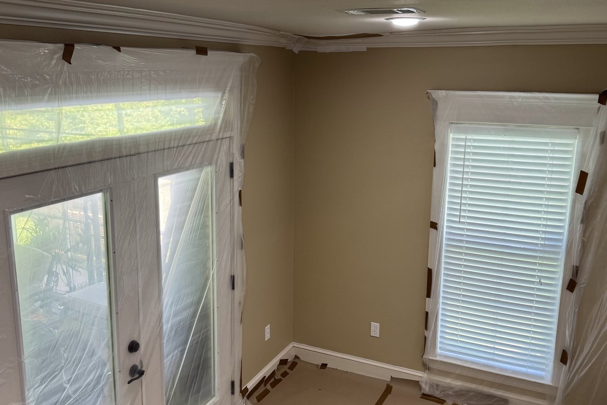 Room masked for interior painting with plastic on the doors