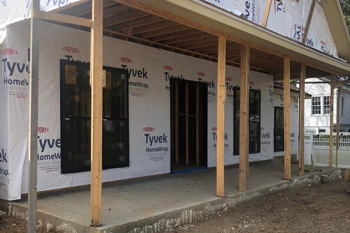 Front porch of a new house in framing with square wood posts