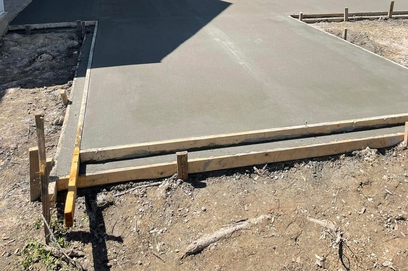 Fresh concrete poured inside a frame of staked wood forms
