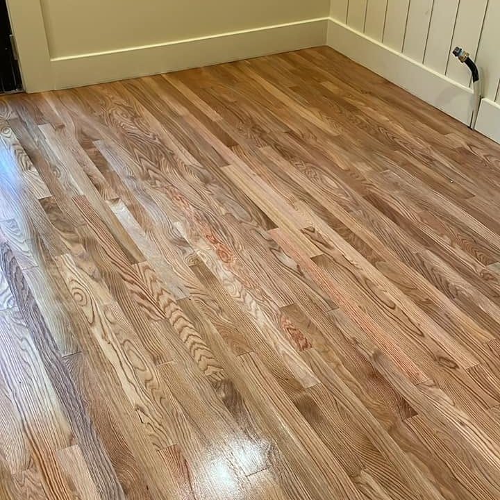Bedroom corner showing natural-tone red oak, refinished to a gloss
