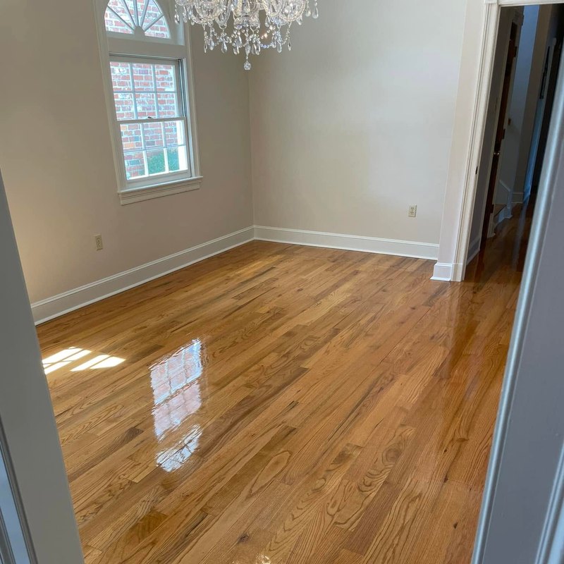 Red oak refinish in a white room with an arched window