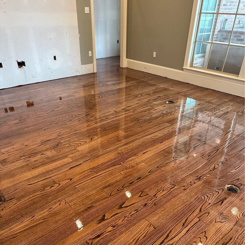 High-gloss medium-brown oak floor with gray-green walls