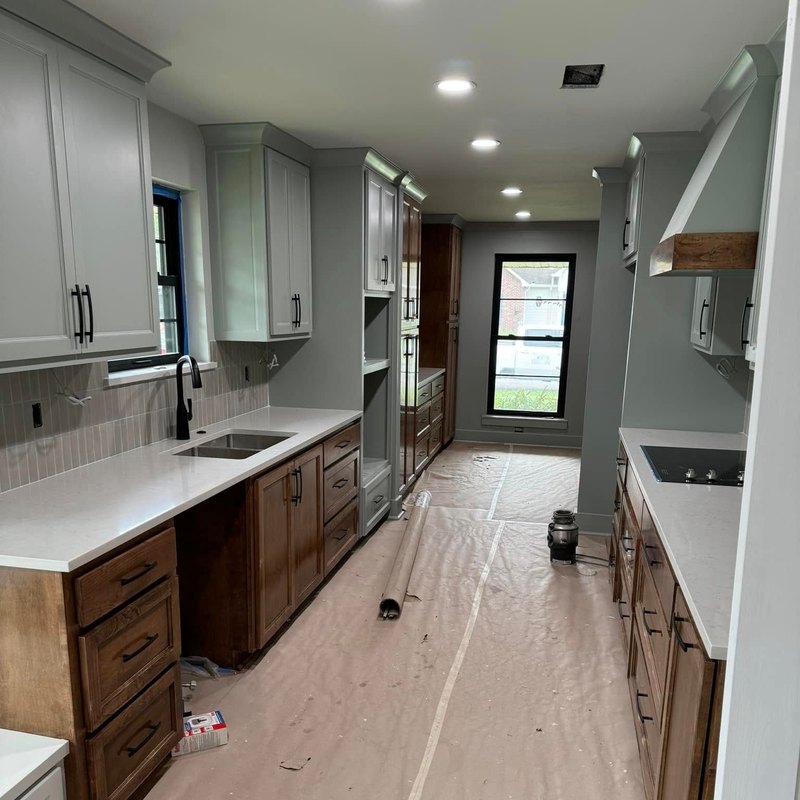Kitchen remodel with light gray uppers and stained lower cabinets