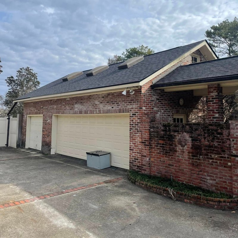 New shingle roof with ridge vents over a three-car garage